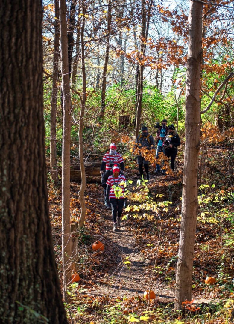 Luke5Adventures taking a person in a chaircycle down the trail in the woods in Cincinnati Parks Caldwell Nature Center