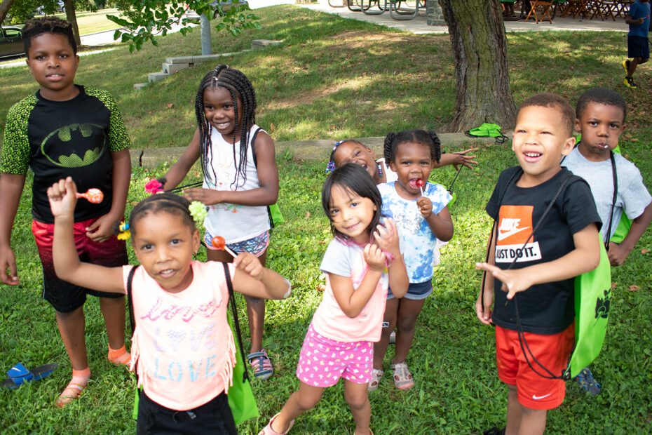 A group of children laughing and signing