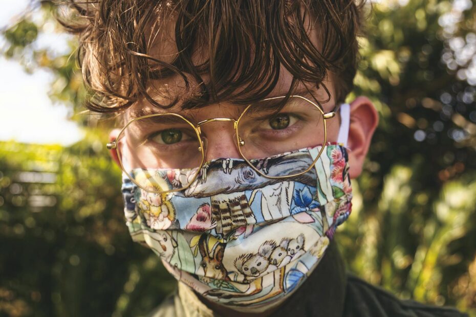 Man outdoors with a face mask on.