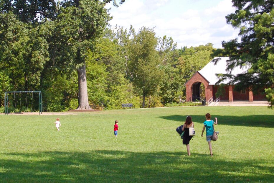 A family walking in an open field at Owls Nest Park