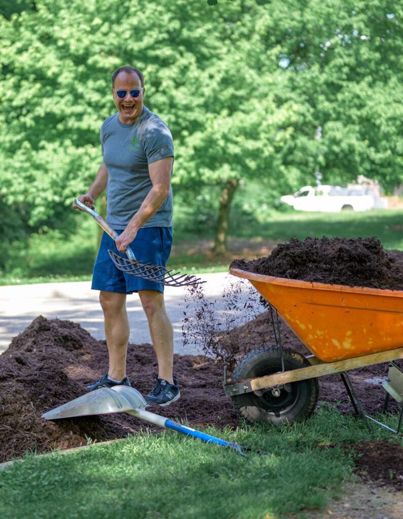 Foundation Board member at the Mayor's Corporate Challenge shoveling mulch