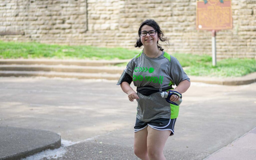 An athlete with disabilities running in the be.well program.