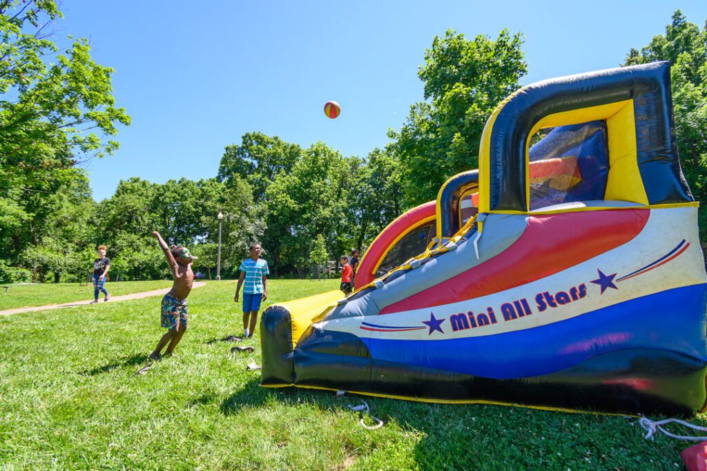 Children enjoying the inflatable games at the MLK Jr. Family Fun Day Juneteenth Celebration. 