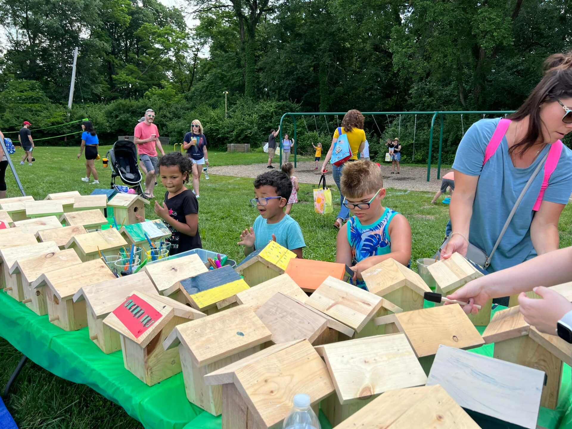 Childen at trail Fest painting bird feeders