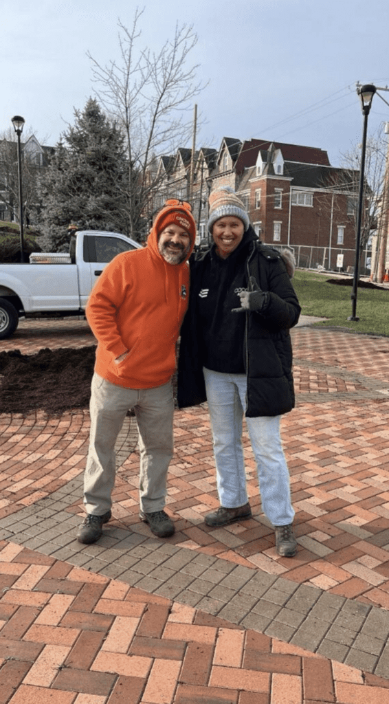 Two men standing on brick pathway