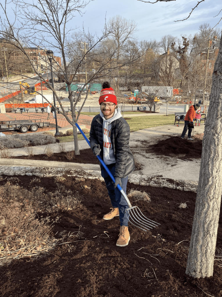 Man standing in dirty with rake
